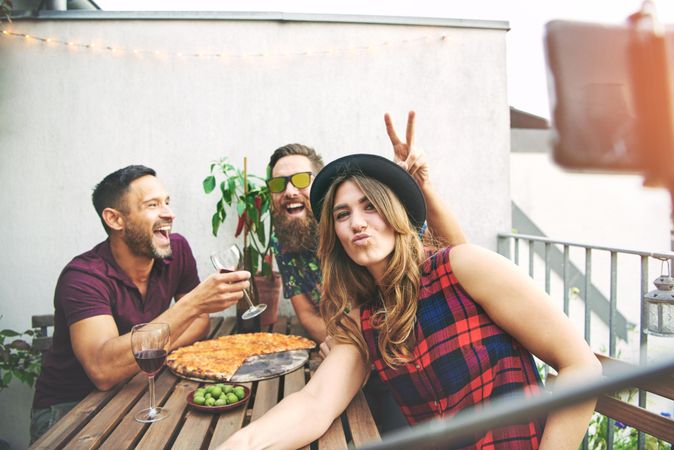 Friends joking around taking a photo on rooftop outside