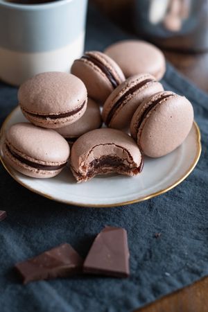 Gold rimmed plate with chocolate macarons