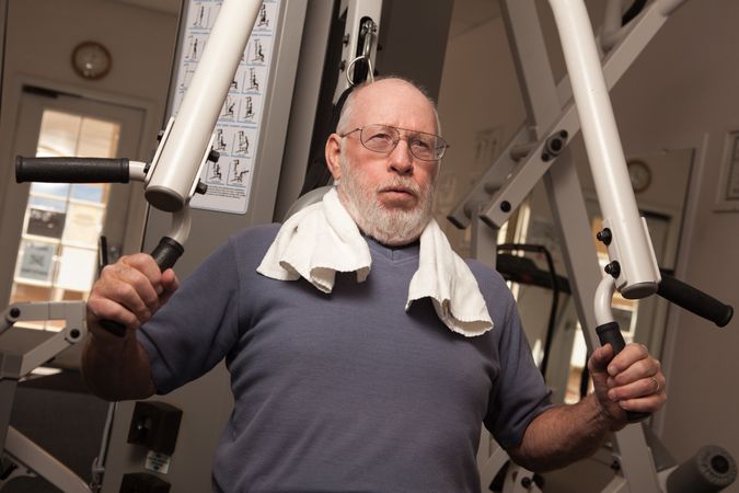 Mature Adult Man Working Out in the Gym.