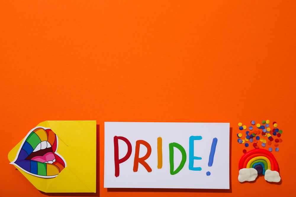 Pride parade concept, symbols on orange background.