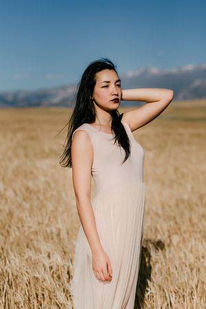 Woman in dress standing in field