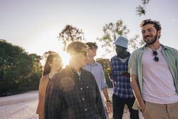 A diverse group of friends enjoy outdoor togetherness, celebrating unity in a vibrant summer.