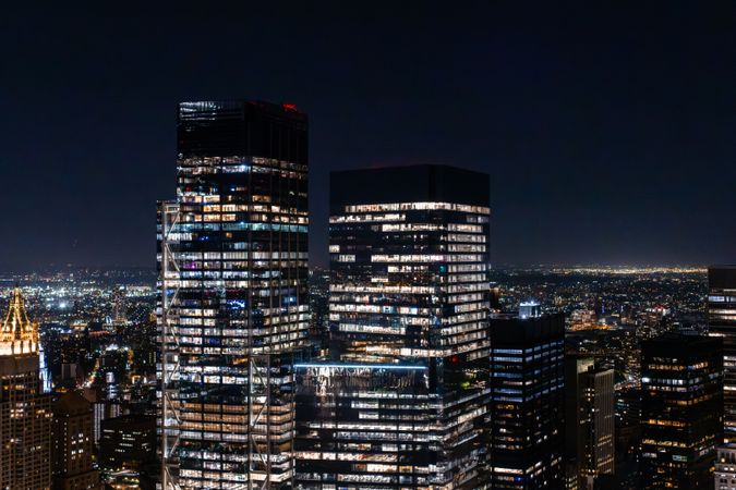 Scenic Aerial New York City View of Downtown Manhattan Architecture. Panoramic Photo of the Business District from a Helicopter. Cityscape with Buildings with Lights in Offices at Night