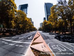 Road between green trees near high rise buildings in Mexico bx6qn5