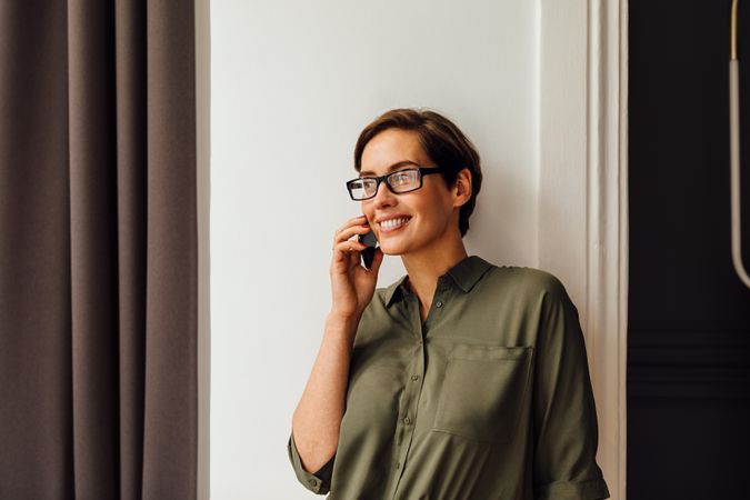 Smiling woman taking a phone call