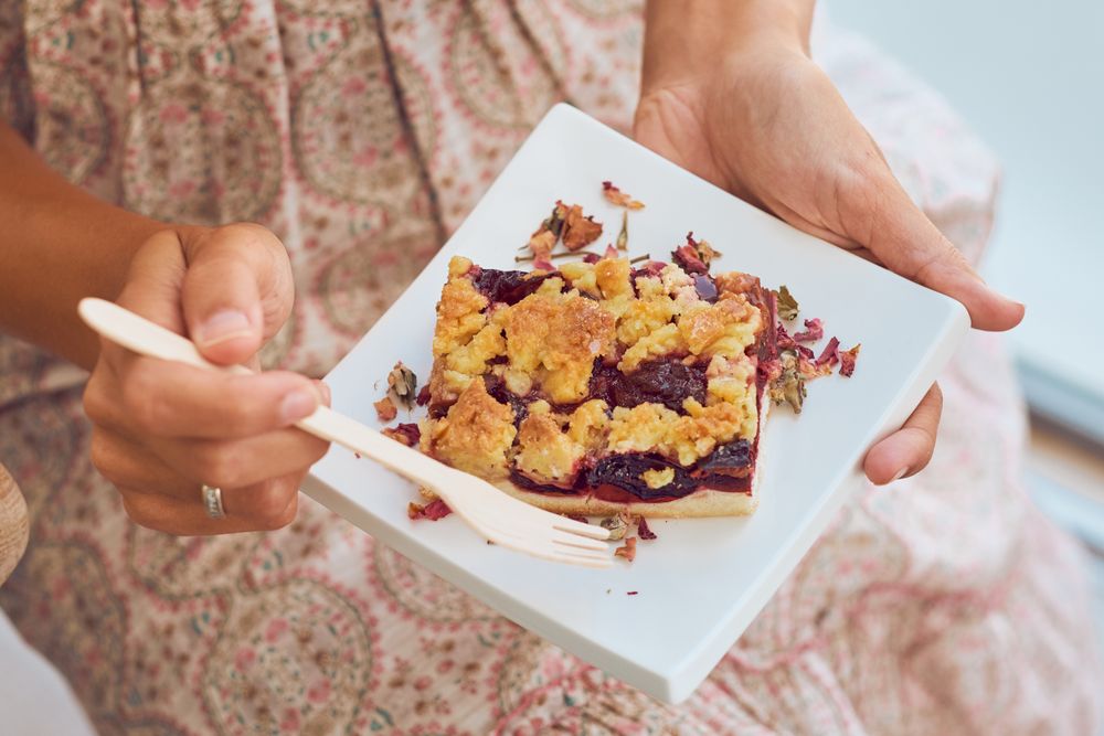 Crop woman eating delicious dessert