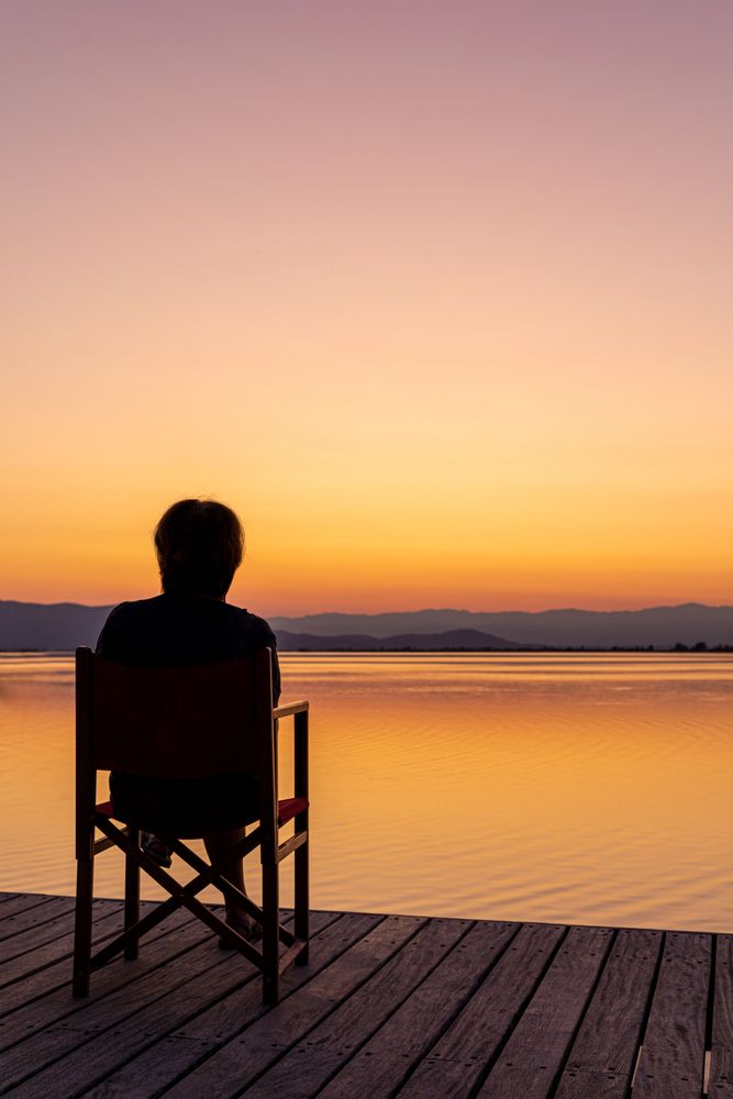 Traveler enjoying sunset sea and mountains