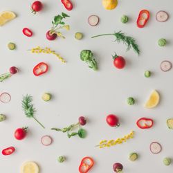Colorful vegetable pattern made of lemon, tomatoes, broccoli and yellow flowers