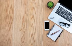 Wooden desktop with basic technology and stationery for work