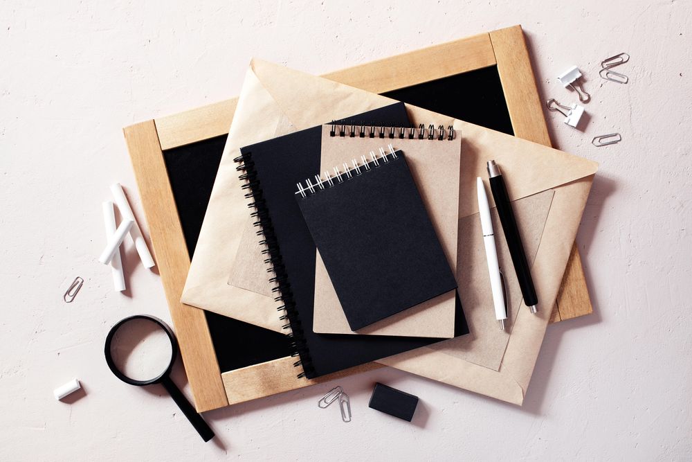 Top view of variety of tan and dark office supplies