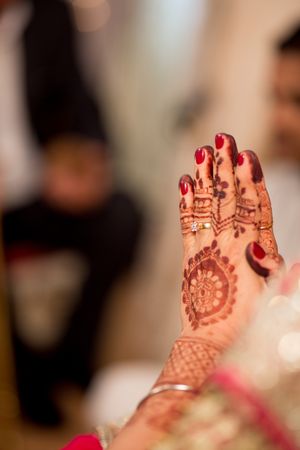 Indian bride's hand with henna tattoo on it