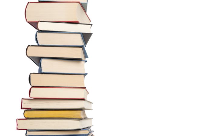 Pile of books stacked isolated on a studio background with space for copy