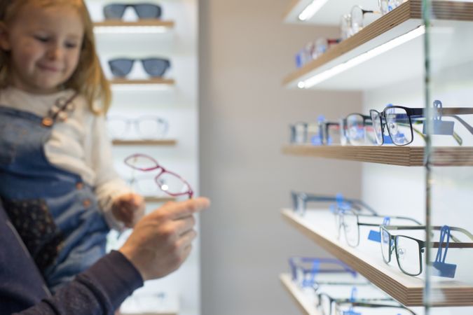 Young girl trying on glasses