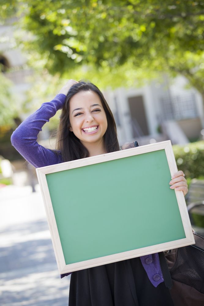 Excited Female Student Holding Blank Green Chalkboard
