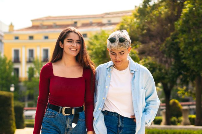 two young women walking in a park