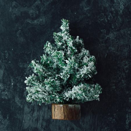 Snowy Christmas tree on marble table top