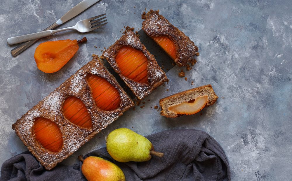 Pear cake and fruits on table