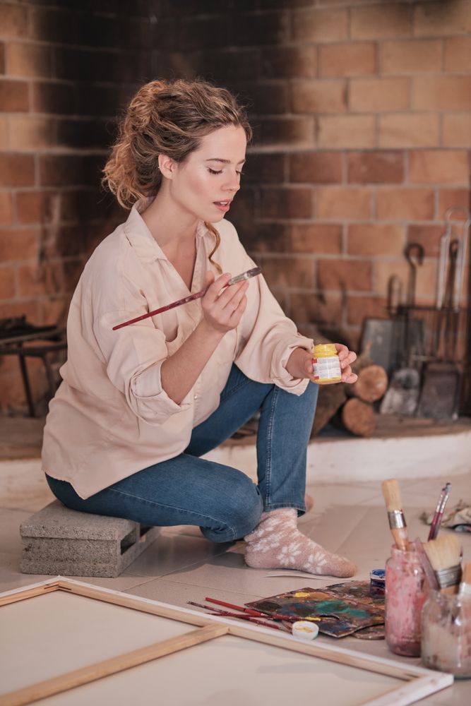 Young woman painting in creative workspace