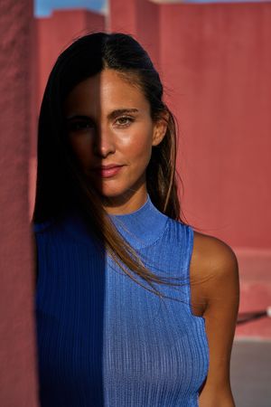 Woman looking at camera in sunlight