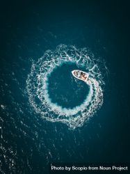Aerial view of boat on water making spiral waves 4OGro4