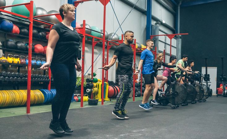 Athletes skipping rope and doing air bike