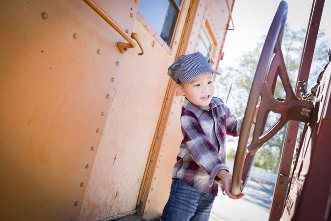 Cute Biracial Boy Having Fun on Railroad Car