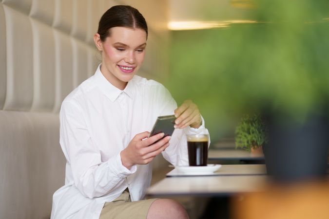 Woman taking photo in cafe