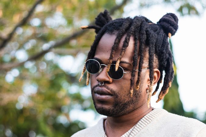 Modern man with dreadlocks and in accessories