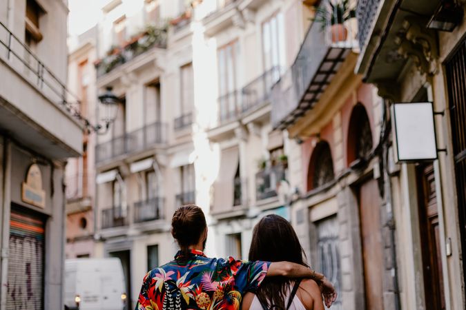 Embracing couple strolling in old city