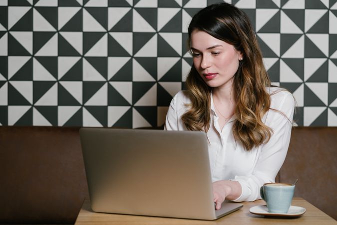 Young woman using laptop in cafe