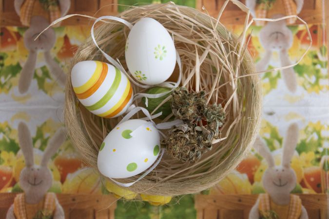 Easter decorated eggs in a basket with dried marijuana
