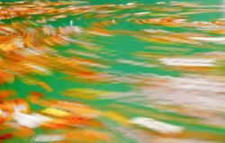 Blurry multicolored water of river flow
