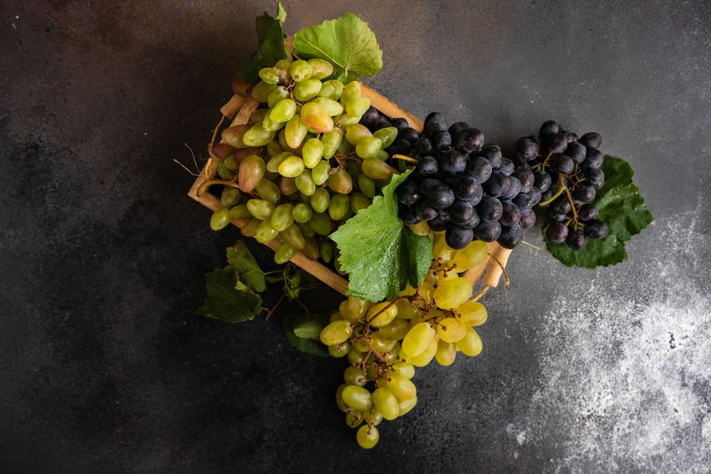 Top view of fresh green & red grapes with leaves