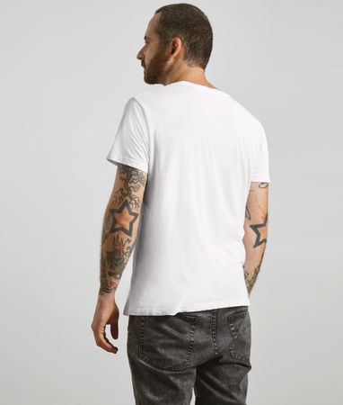 Rearview of bearded man in plain t-shirt and dark jeans