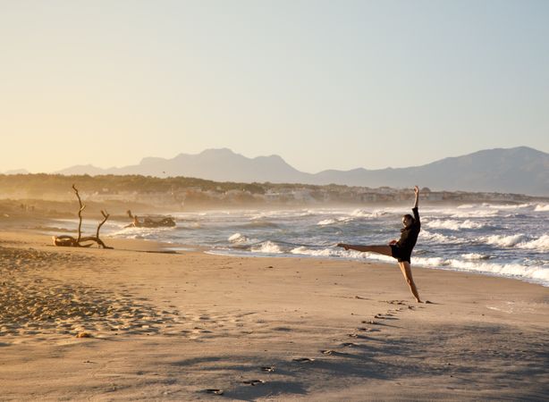 Woman with dancing near water on shore