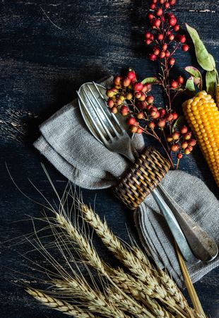Cutlery with autumnal decorations of wheat, berries and corn