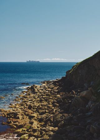Rocky coast looking out to a ship