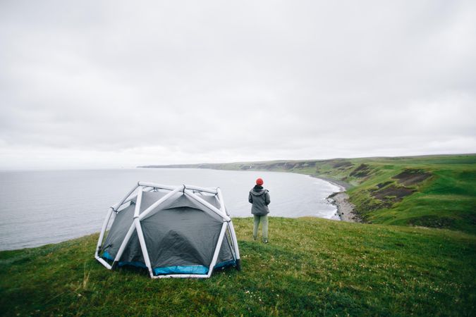 Man standing next to tent