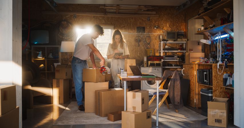 Diverse Family Business Owners Working in Home Garage And Talking.