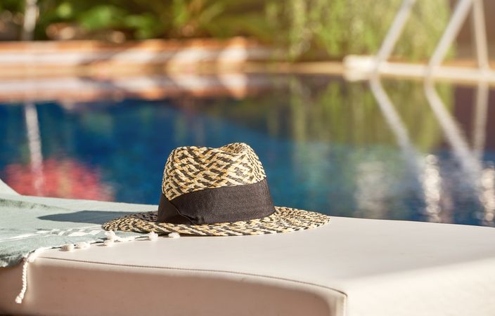 Straw hat with marks near water