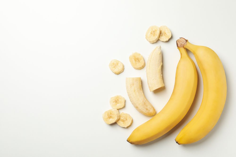 Bananas on blank background, top view. Fresh fruit
