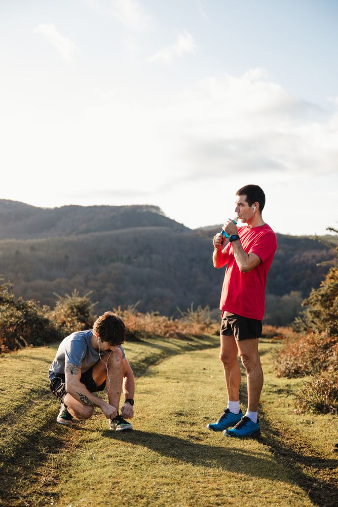 Sportive males taking break after running in mountains