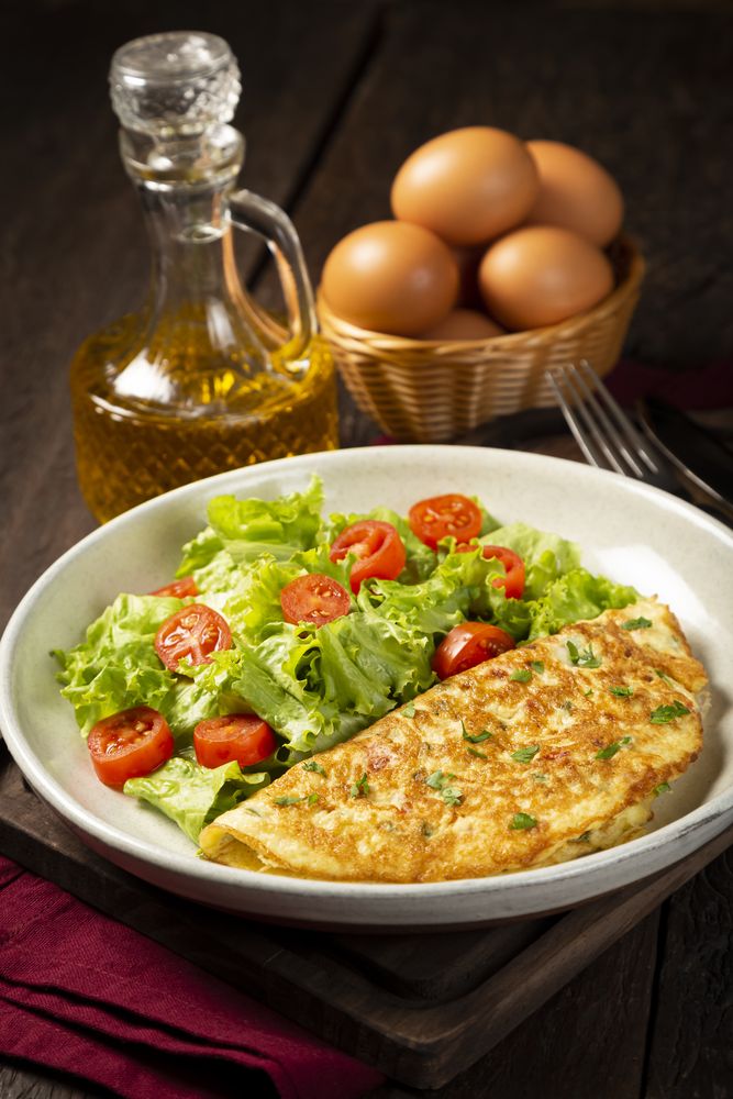 Omelet with cheese and lettuce and tomato salad.