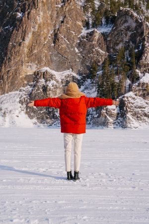 Frozen woman wrapped in scarf on winter day