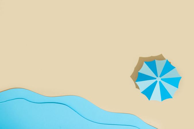 Paper beach with umbrella and sea
