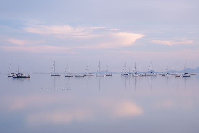 Boats on calm sea water in evening