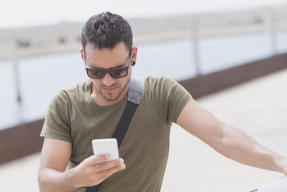 Male looking down at cellphone