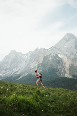Unrecognizable man with backpack hiking in Pyrenees mountains