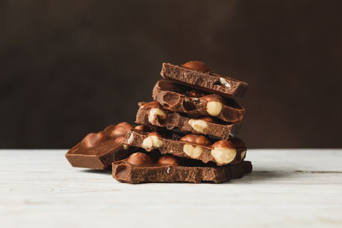 Tasty chocolate pieces on wooden table