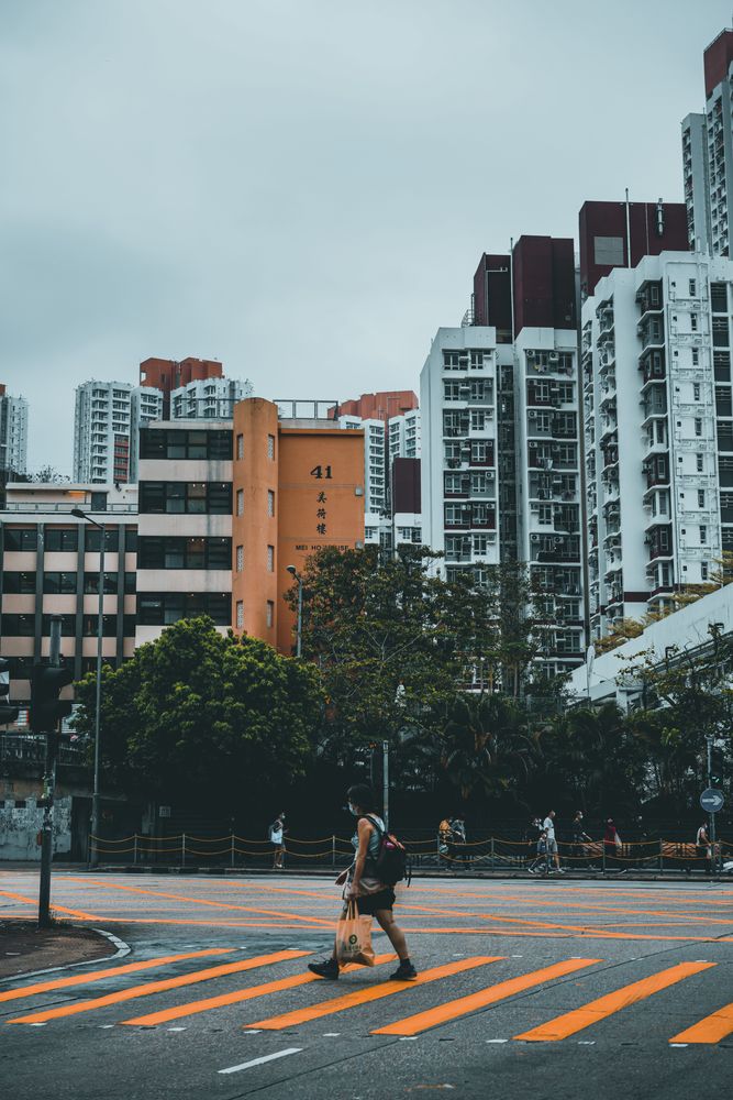 Woman walking the pedestrian lane near city building